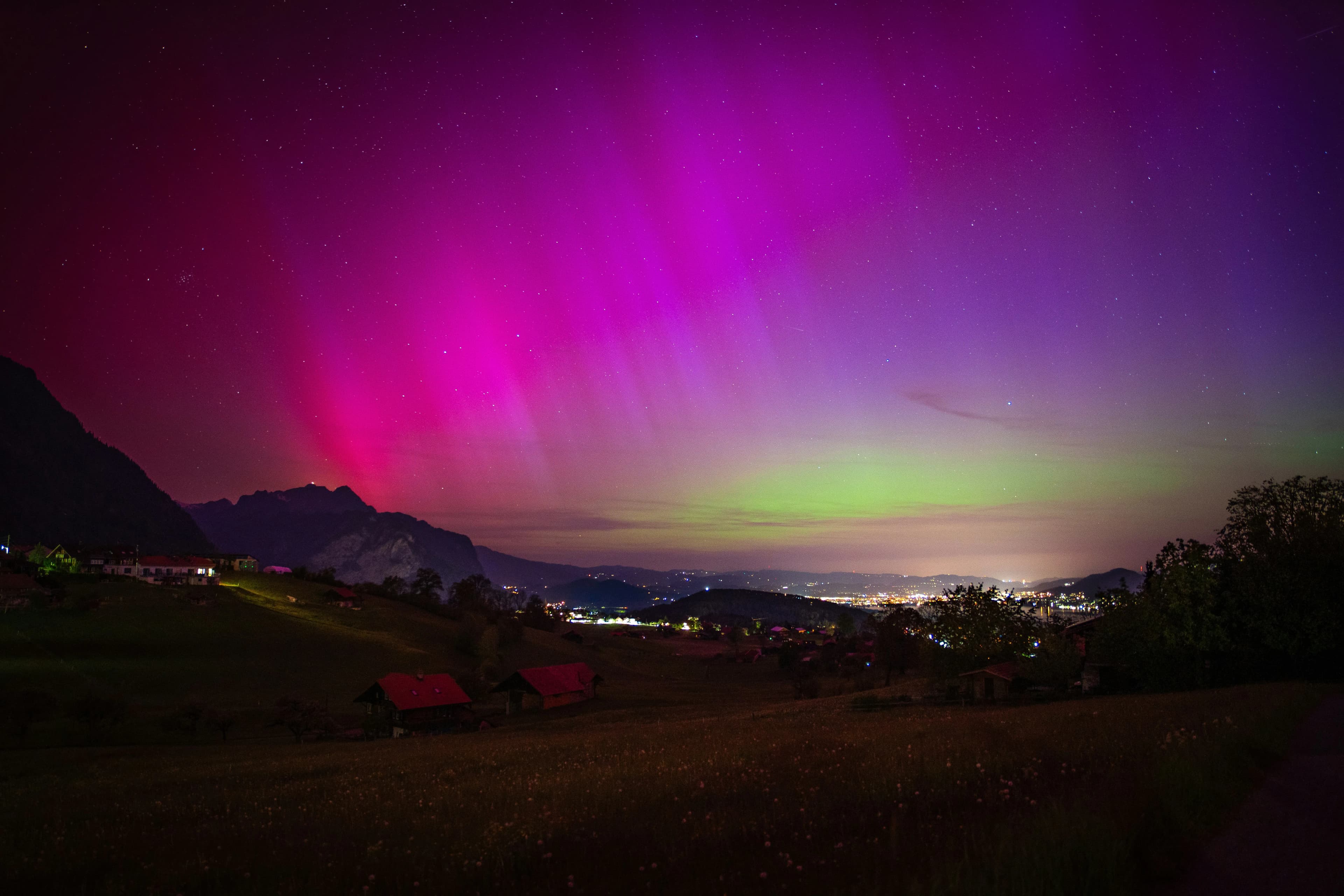 Northern lights partially visible through clouds