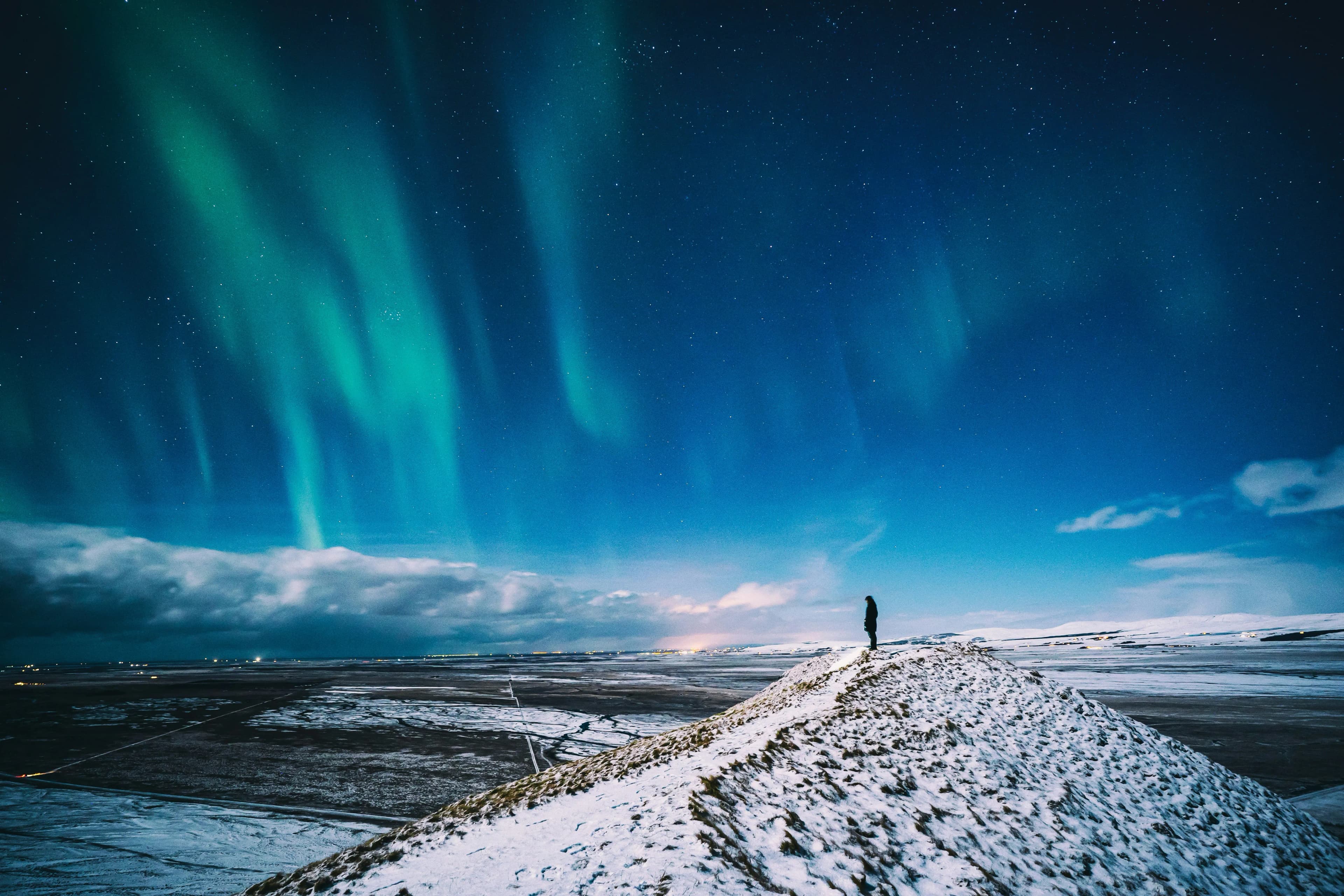 Aurora borealis science — green and purple lights over Arctic landscape