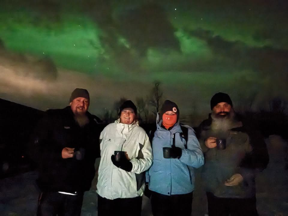 Trish and Tony Stowe beneath the northern lights in Norway